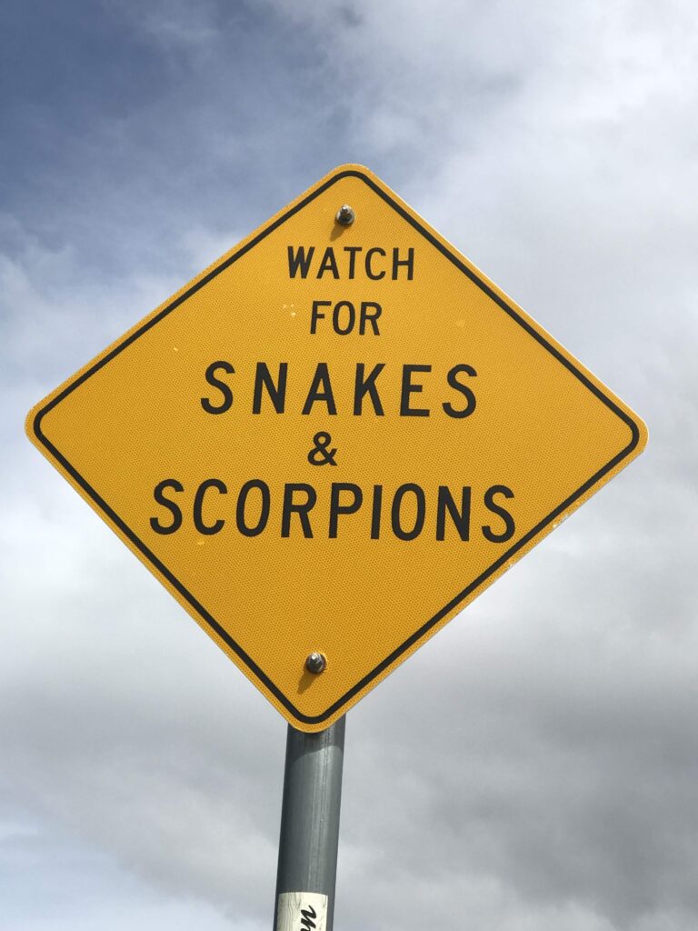 Sign that says, "Watch for Snakes and Scorpions."