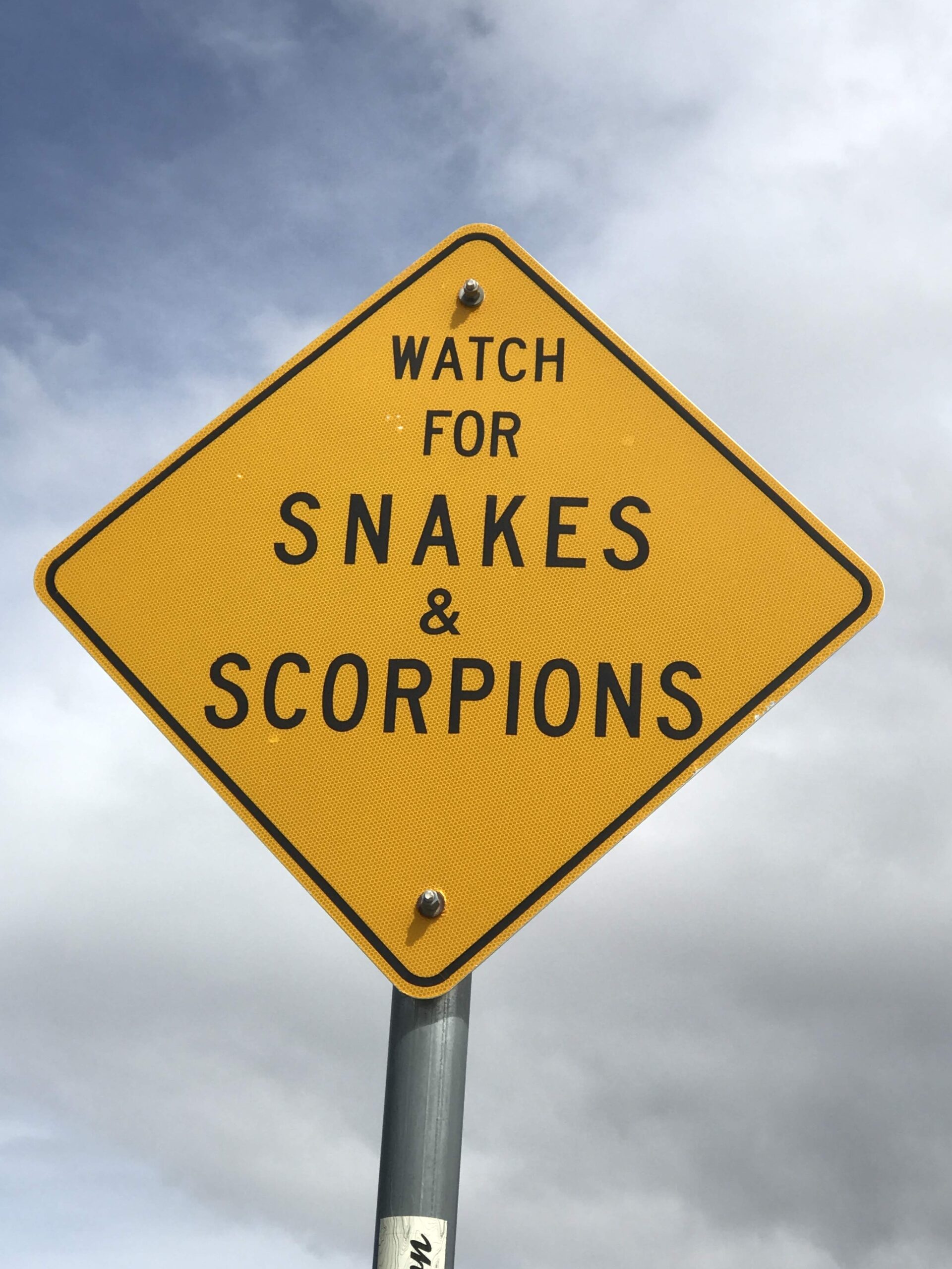 Sign that says, "Watch for Snakes and Scorpions."